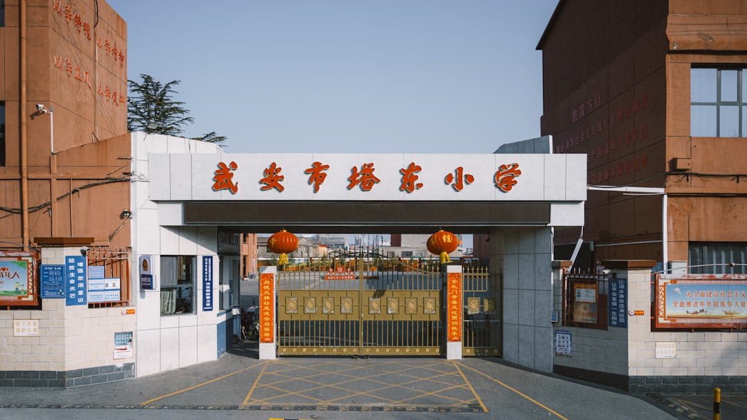Entrance to a school with golden gates and lanterns