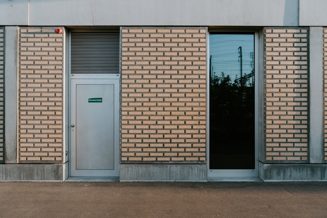 a tall brick building with a door and windows