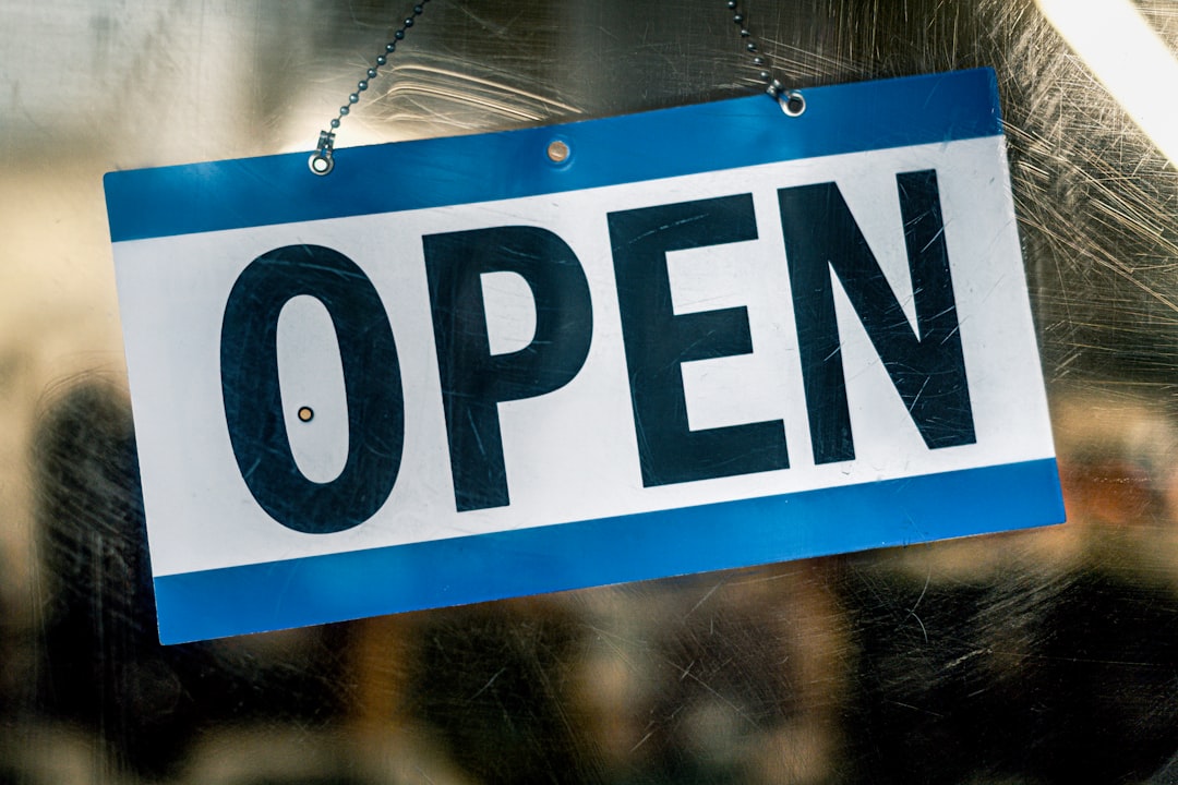 Open sign hanging on a glass door