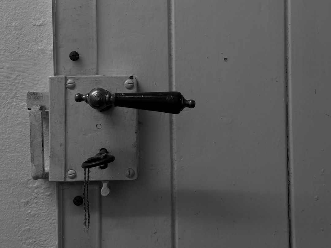 Close-up of an old door handle and lock with key.
